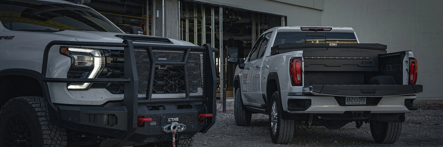 Two trucks with CTA bumpers, truck tool boxes, power running boards, lights, winches, auxillary fuel transfer tanks, and other Chandler Truck Accessories installed