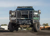 Front-facing image of a Chevy Silverado equipped with a grill guard front bumper, winch, and recovery gear from Chandler Truck Accessories | CTA