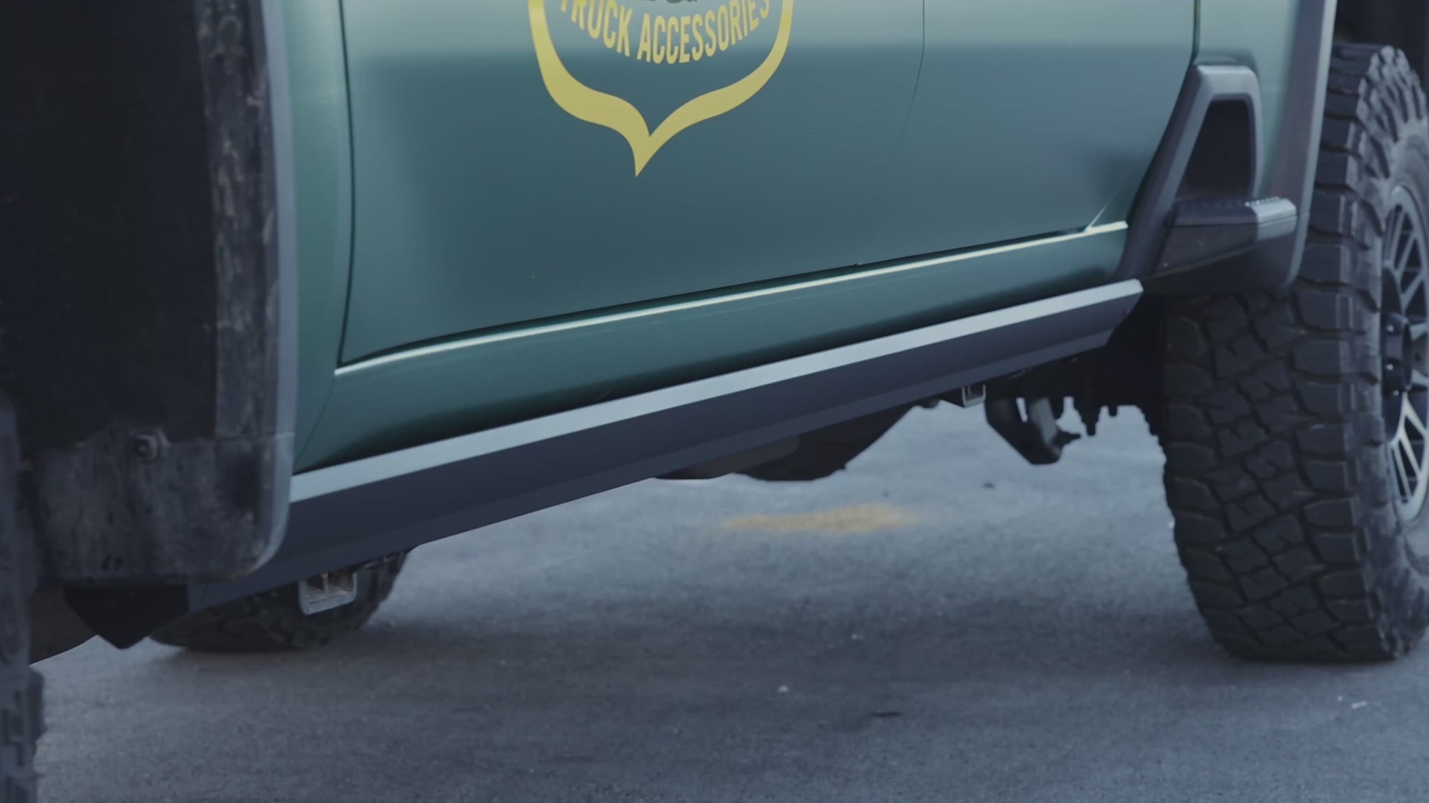 Video showing retracting electric power running boards with person stepping into truck